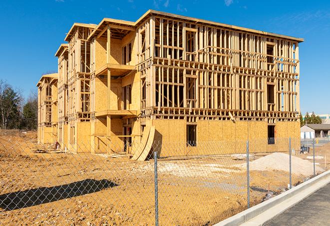 workers protected by temporary barrier fence during building maintenance in Avon Lake